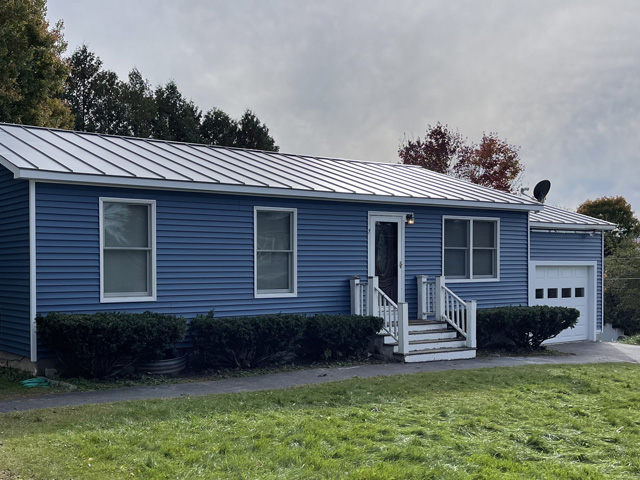 new blue vinyl siding installed on home